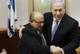 FILE - In this Jan. 2, 2011 file photo, Israel's Prime Minister Benjamin Netanyahu, right, hugs Meir Dagan, then outgoing Mossad chief, after thanking him at the beginning of the weekly cabinet meeting in Jerusalem. Israeli media on Thursday, 2 June, 2011, cite the recently retired Mossad chief Meir Dagan as saying there are no plans to attack Iran within the next two years.